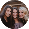 Three girls standing close to each other and smiling
